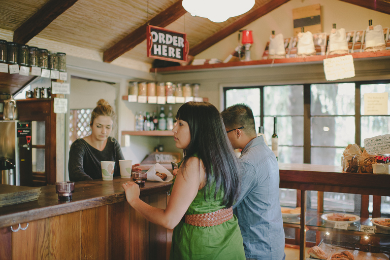 Big sur bakery engagement photo ordering drinks